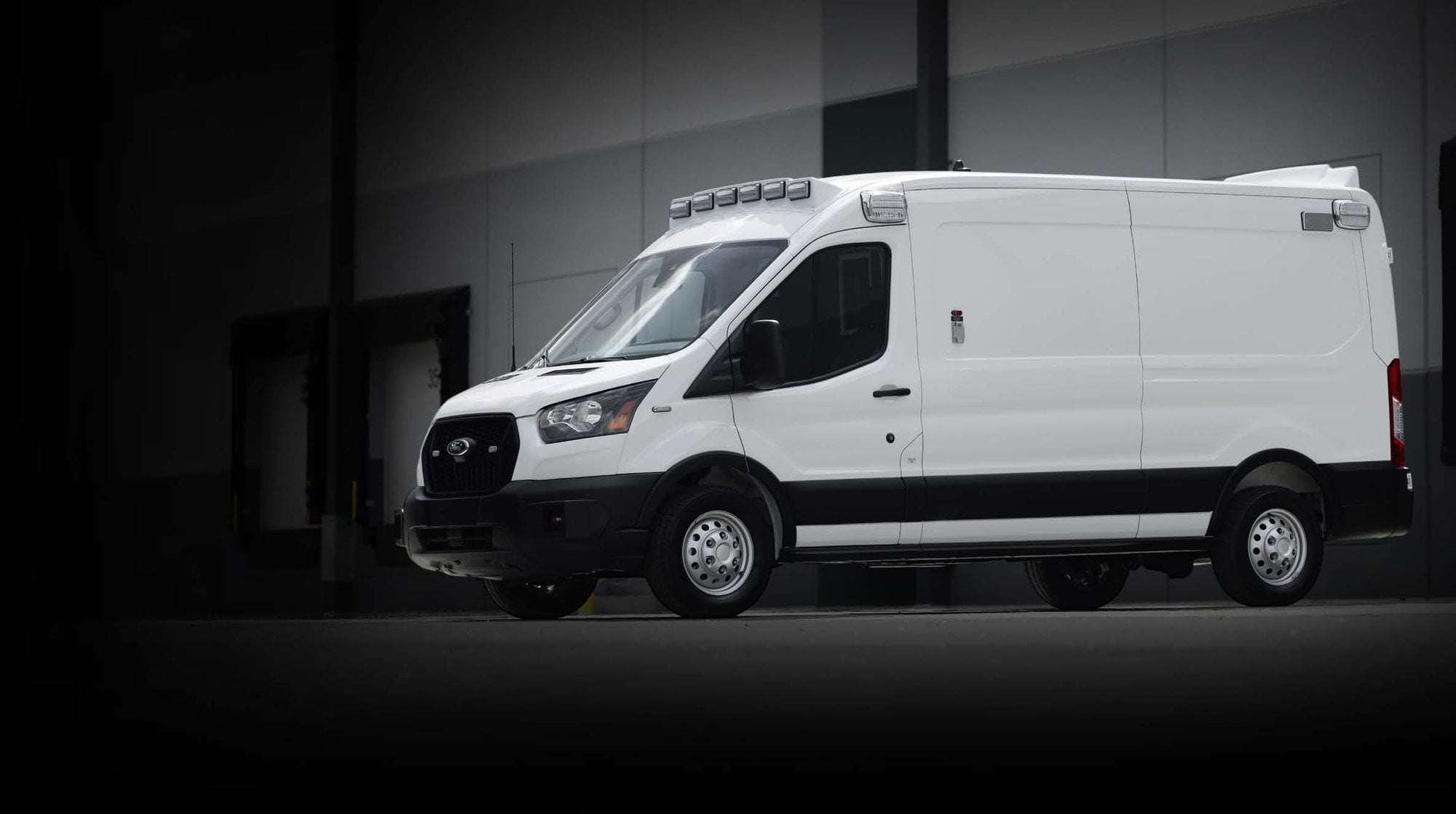 White SIV Type II ambulance parked at a loading dock